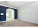 Spacious carpeted living room with elegant wainscoting and archway at 3228 Trinity Mill Cir, Dacula, GA 30019