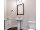 Powder room with corner cabinet, stand sink and decorative mirror at 3228 Trinity Mill Cir, Dacula, GA 30019