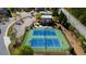 An aerial view shows two tennis courts, a community pool, and surrounding homes at 3228 Trinity Mill Cir, Dacula, GA 30019