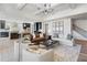 Open-concept living room with kitchen view, featuring stylish furniture and natural light at 5395 Keepsake Court, Cumming, GA 30040