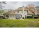 Spacious backyard view with patio, outdoor dining set, lush green lawn, and privacy fencing at 5713 Brynwood Nw Cir, Acworth, GA 30101
