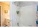Bathroom with white tiled shower, shower caddy, sink vanity and tile flooring at 5713 Brynwood Nw Cir, Acworth, GA 30101