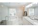 Bright bathroom featuring a soaking tub, double vanity, and large windows at 5713 Brynwood Nw Cir, Acworth, GA 30101