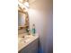 Bathroom featuring a vintage-style vanity with elegant decor, decorative mirror and warm lighting at 5713 Brynwood Nw Cir, Acworth, GA 30101