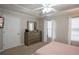 Bright bedroom featuring a ceiling fan, a dresser with a mirror, and natural light from the windows at 5713 Brynwood Nw Cir, Acworth, GA 30101