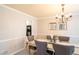 Well-lit dining room with a chandelier, wall trim and neutral color palette at 5713 Brynwood Nw Cir, Acworth, GA 30101