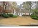 Charming white home featuring a manicured lawn and mature trees at 5713 Brynwood Nw Cir, Acworth, GA 30101
