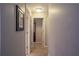 Bright hallway with neutral walls and carpet, leading to various rooms in the home at 5713 Brynwood Nw Cir, Acworth, GA 30101