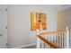 Upstairs hallway features neutral walls with a painting hung and a white door and trim at 5713 Brynwood Nw Cir, Acworth, GA 30101