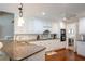 Well-appointed kitchen featuring granite countertops, white cabinetry and wood floors at 5713 Brynwood Nw Cir, Acworth, GA 30101