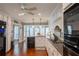 Open kitchen with stainless appliances, granite countertops, and wood floors at 5713 Brynwood Nw Cir, Acworth, GA 30101