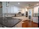 Stylish kitchen boasting granite countertops, white cabinets, and tile backsplash at 5713 Brynwood Nw Cir, Acworth, GA 30101