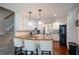 Spacious kitchen with bar seating, granite countertops, and stairs leading up at 5713 Brynwood Nw Cir, Acworth, GA 30101