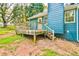 Back of home showcasing a wooden deck, green grass, and natural landscape, perfect for relaxing at 622 Jockey Ln, Auburn, GA 30011