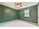 Spacious bedroom features green walls, carpet, and a ceiling fan at 622 Jockey Ln, Auburn, GA 30011