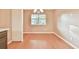 Bright dining area with wood floors and a chandelier-style light fixture at 622 Jockey Ln, Auburn, GA 30011