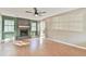 Spacious living room with a brick fireplace and hardwood floors, filled with natural light at 622 Jockey Ln, Auburn, GA 30011