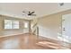 Bright living room featuring hardwood floors, a modern ceiling fan, and neutral wall colors at 622 Jockey Ln, Auburn, GA 30011
