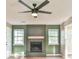 Living room features a brick fireplace and hardwood floors with a ceiling fan at 622 Jockey Ln, Auburn, GA 30011