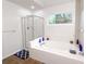 Bright bathroom features a large soaking tub with tile surround and a glass shower at 3875 Ivy Run Cir, Duluth, GA 30096