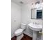 Powder room features a pedestal sink, neutral colors, and wood look flooring at 3875 Ivy Run Cir, Duluth, GA 30096