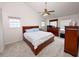 Spacious bedroom featuring a ceiling fan, neutral carpet, and natural light at 3875 Ivy Run Cir, Duluth, GA 30096