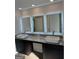 Elegant bathroom with double vanity, granite countertop, and illuminated mirrors at 390 River Walk Farm Parkway Lot 47, Covington, GA 30014