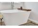 Bright bathroom featuring a modern freestanding tub with stylish fixtures and natural light at 390 River Walk Farm Parkway Lot 47, Covington, GA 30014