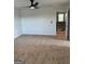 Spacious bedroom featuring neutral carpeting, a ceiling fan, and an open doorway at 390 River Walk Farm Parkway Lot 47, Covington, GA 30014