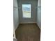 Walk-in closet with carpet flooring, wire shelving and a window at 390 River Walk Farm Parkway Lot 47, Covington, GA 30014