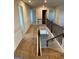 Upstairs hallway showcasing neutral carpet and paint and staircase at 390 River Walk Farm Parkway Lot 47, Covington, GA 30014