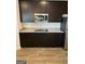 Modern kitchen with sleek dark cabinets, stainless steel appliances, and light speckled countertops at 390 River Walk Farm Parkway Lot 47, Covington, GA 30014