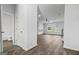 Bright and airy living area with wood-look floors, seamlessly connecting to the kitchen and bathrooms at 390 River Walk Farm Parkway Lot 47, Covington, GA 30014