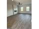 Spacious living room with wood-look floors, contemporary fireplace, and ample natural light, perfect for entertaining at 390 River Walk Farm Parkway Lot 47, Covington, GA 30014