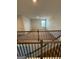 Loft area featuring neutral walls and carpet, window, and wrought iron railing at 390 River Walk Farm Parkway Lot 47, Covington, GA 30014
