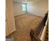 Upstairs loft area featuring neutral carpet and a window at 390 River Walk Farm Parkway Lot 47, Covington, GA 30014