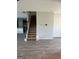 Open-concept home showcasing a carpeted staircase leading to the upper level with wood-look flooring at 390 River Walk Farm Parkway Lot 47, Covington, GA 30014