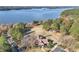 Aerial view showcases the community clubhouse nestled near a serene lake, surrounded by vibrant trees at 6048 Golf View Xing, Locust Grove, GA 30248