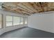 Spacious unfinished basement featuring exposed utilities and multiple windows, presenting opportunities for personalization at 6048 Golf View Xing, Locust Grove, GA 30248