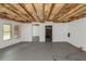 Unfinished basement featuring exposed wooden ceiling and smooth floor, offering potential for various customization projects at 6048 Golf View Xing, Locust Grove, GA 30248