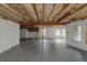 Unfinished basement with exposed wooden ceiling, smooth floor, and windows for natural light, perfect for customization at 6048 Golf View Xing, Locust Grove, GA 30248
