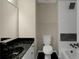 Well-appointed bathroom featuring a black marble countertop, modern fixtures, and a tiled shower and tub at 6048 Golf View Xing, Locust Grove, GA 30248
