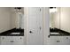 Dual vanity bathroom featuring matching granite countertops and modern lighting fixtures at 6048 Golf View Xing, Locust Grove, GA 30248