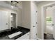 Stylish bathroom featuring a black marble countertop and modern fixtures, seamlessly blending style with functionality at 6048 Golf View Xing, Locust Grove, GA 30248