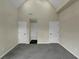 A spacious bedroom with vaulted ceiling with gray carpet and neutral walls, ready for customization at 6048 Golf View Xing, Locust Grove, GA 30248