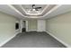 Spacious bedroom featuring a modern ceiling fan and trey ceiling for a luxurious feel at 6048 Golf View Xing, Locust Grove, GA 30248