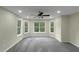Bright bedroom featuring neutral walls, gray carpet and plenty of windows for lots of natural light at 6048 Golf View Xing, Locust Grove, GA 30248