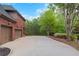 Spacious driveway leading to a two-car garage, surrounded by lush landscaping at 6048 Golf View Xing, Locust Grove, GA 30248