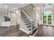 Elegant entryway features staircase with iron spindles and view of the front door at 6048 Golf View Xing, Locust Grove, GA 30248