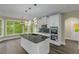 Bright kitchen features a center island, modern light fixtures, and stainless steel appliances at 6048 Golf View Xing, Locust Grove, GA 30248